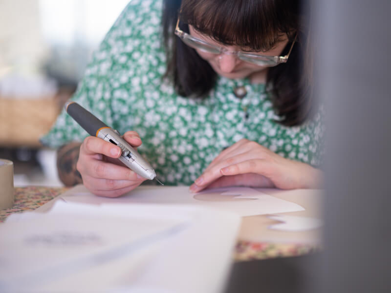 woman doing screen printing at home